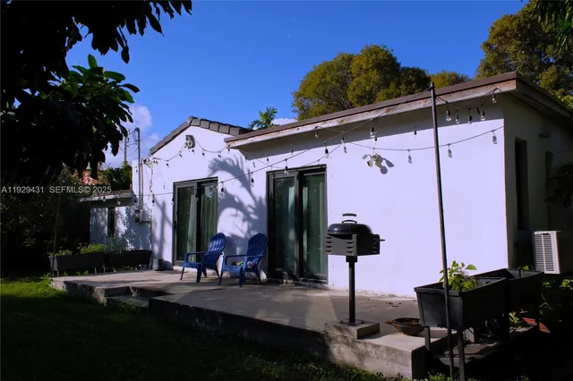 a view of a backyard with wooden fence and a bench