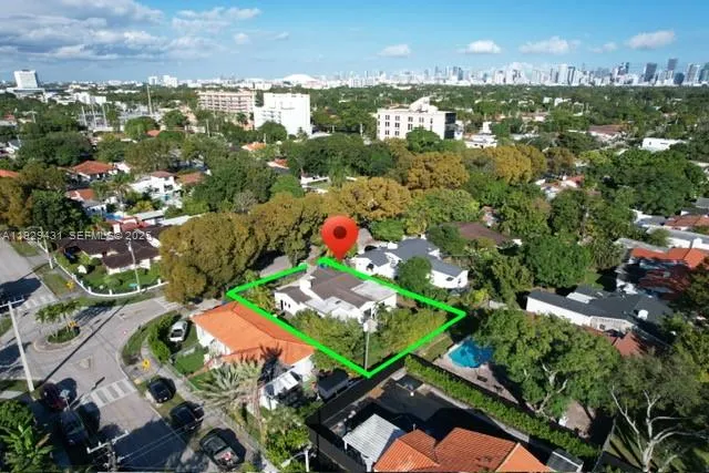 an aerial view of residential houses with outdoor space and street view