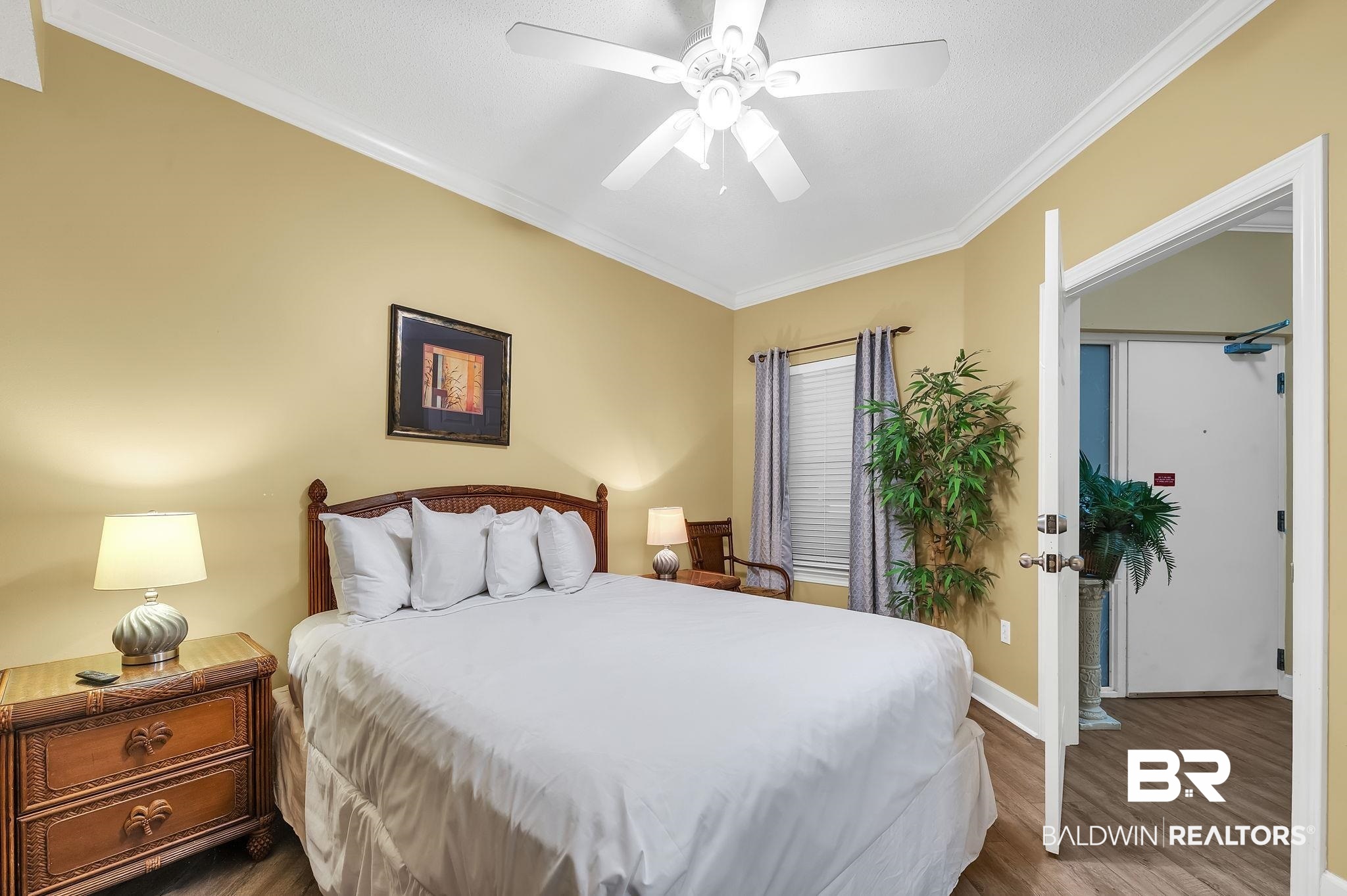 27580 Canal Road, Unit 1214 AND BOAT SLIP #62 Orange Beach, AL 36561 - Photo 34 of 67 Bedroom with baseboards, crown molding, a ceiling fan, and wood finished floors