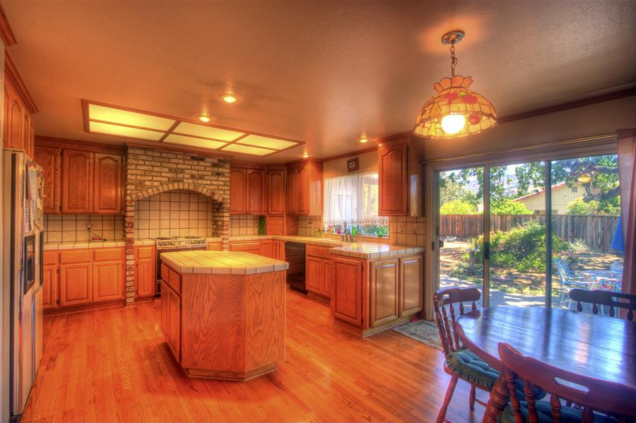 2805 Roop Road Gilroy, CA 95020 - Photo 13 of 20 a kitchen with stainless steel appliances granite countertop a stove and wooden floor