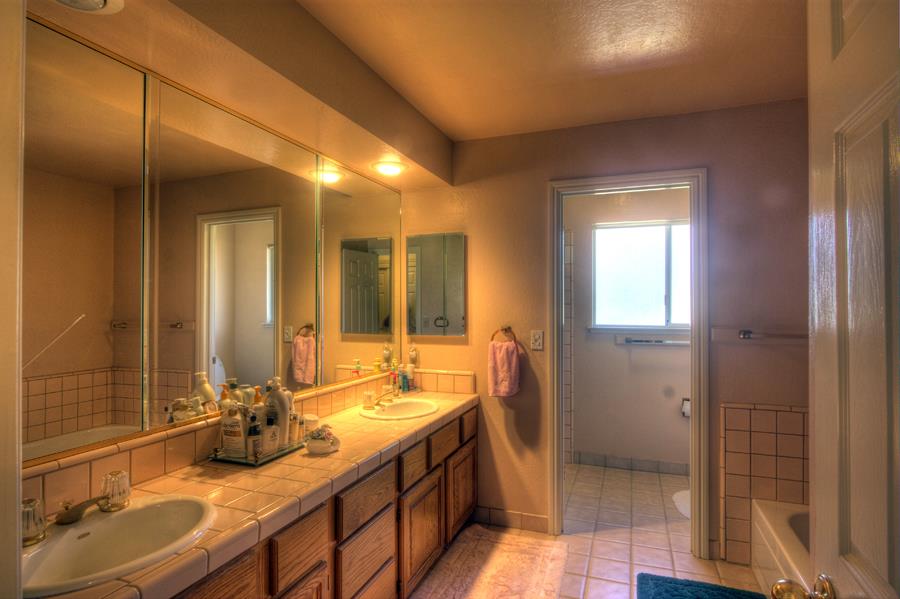 2805 Roop Road Gilroy, CA 95020 - Photo 8 of 20 a bathroom with double vanity and a mirror