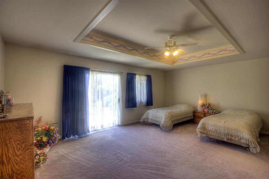 2805 Roop Road Gilroy, CA 95020 - Photo 9 of 20 a spacious bedroom with a bed and a chandelier