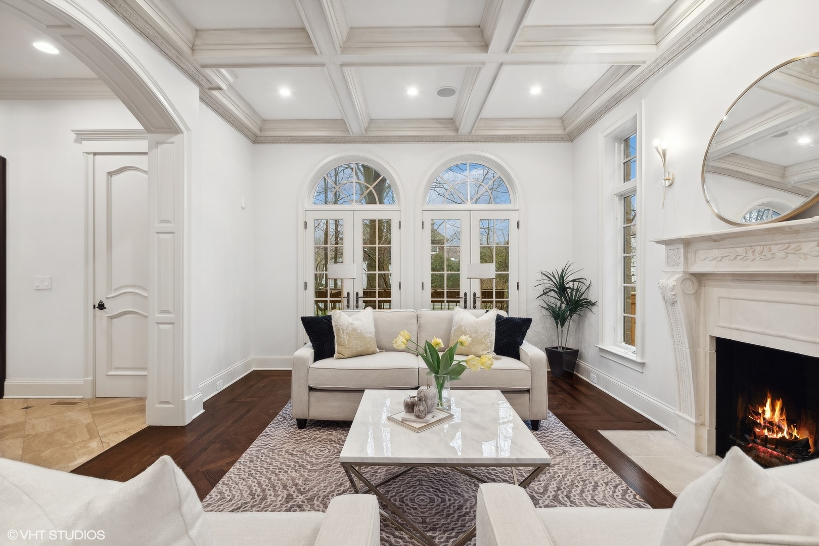 1016 Westmoor Road Winnetka, IL 60093 - Photo 6 of 48 a living room with furniture a fireplace and a chandelier