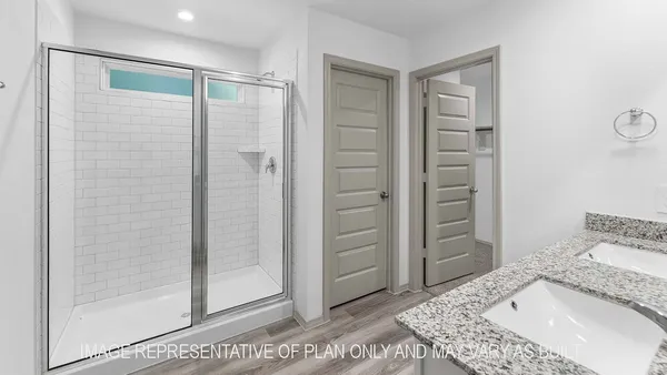 a bathroom with a granite countertop sink and shower