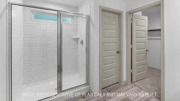 a bathroom with a glass shower door