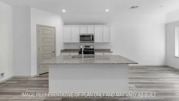 a kitchen with kitchen island a sink stainless steel appliances and cabinets