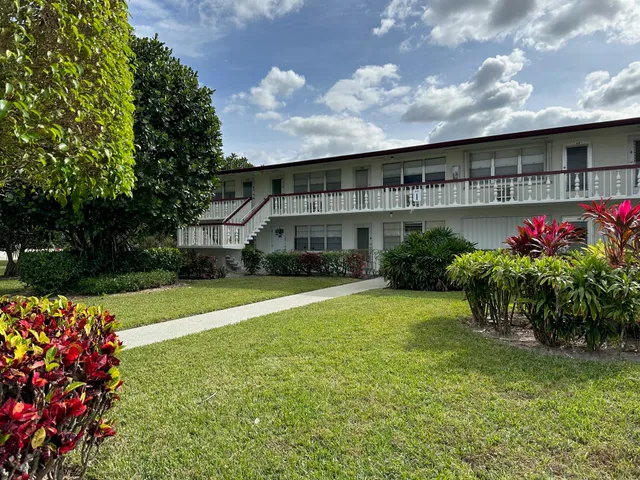 a front view of house with a garden