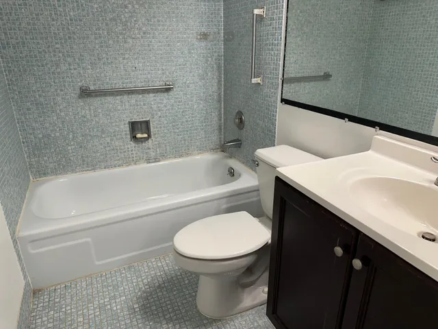 a bathroom with a sink a toilet and bathtub