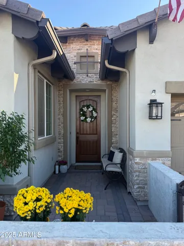a large bed sitting in a bedroom next to a window and a chandelier