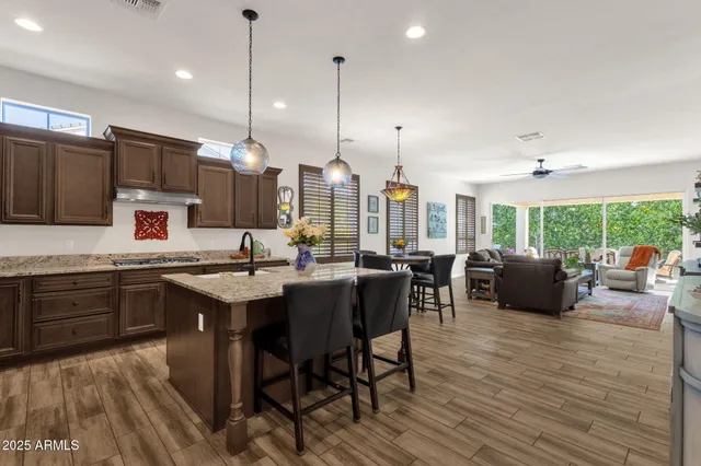 a living room with furniture a flat screen tv and a window