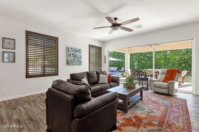 a view of a roof deck with table and chairs under an umbrella