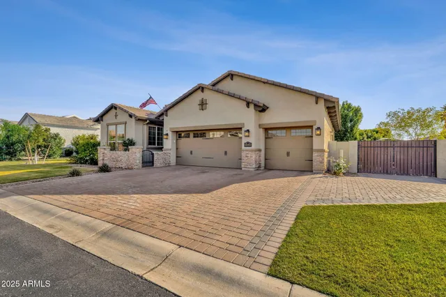 a kitchen with stainless steel appliances kitchen island granite countertop a sink refrigerator and cabinets