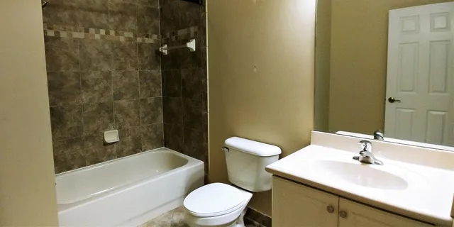 a bathroom with a sink a toilet and bathtub