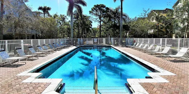 a view of a backyard with swimming pool