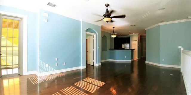 a view of a room with a window and wooden floor