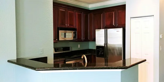 a kitchen with a refrigerator and a sink