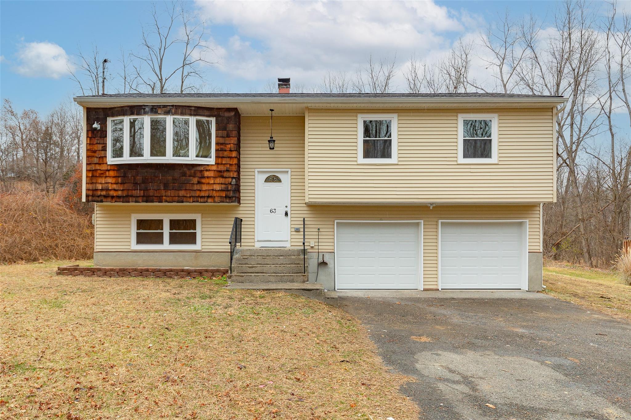 63 Camelot Road Poughkeepsie, NY 12601 - Photo 1 of 1 a front view of a house with a yard and garage