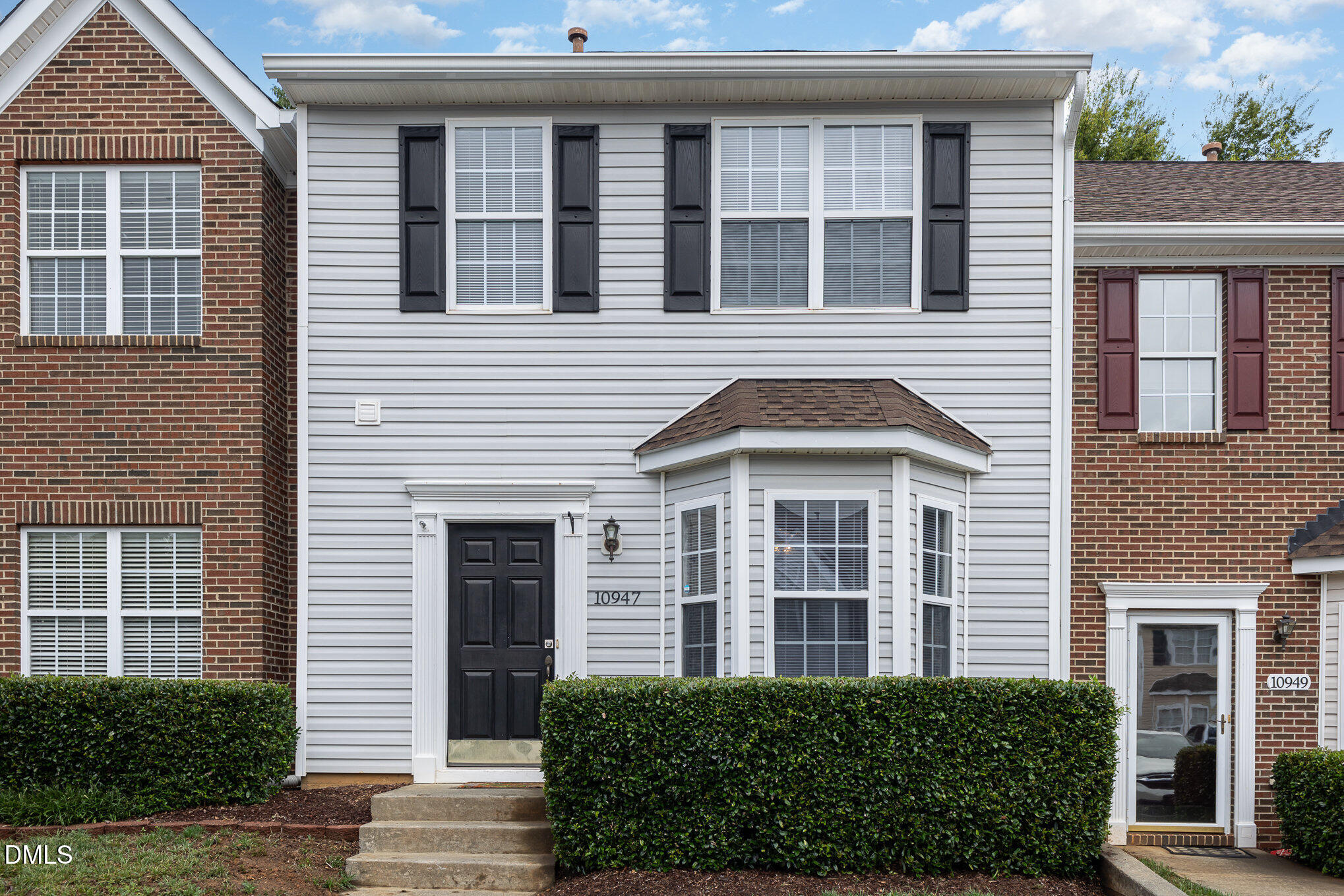 10947 Pendragon Place Raleigh, NC 27614 - Photo 1 of 21 a front view of a building with a garden
