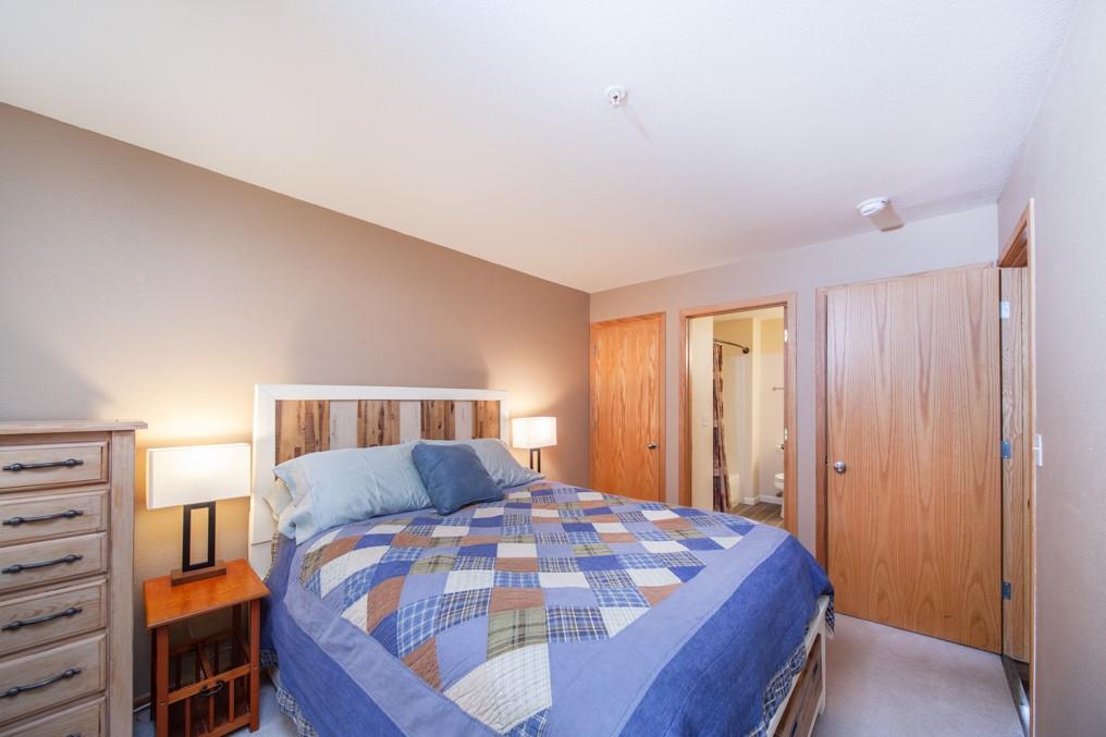 91199 Ryan Gulch Road, Unit A5 Silverthorne, CO 80498 - Photo 12 of 31 a bedroom with a bed and a window