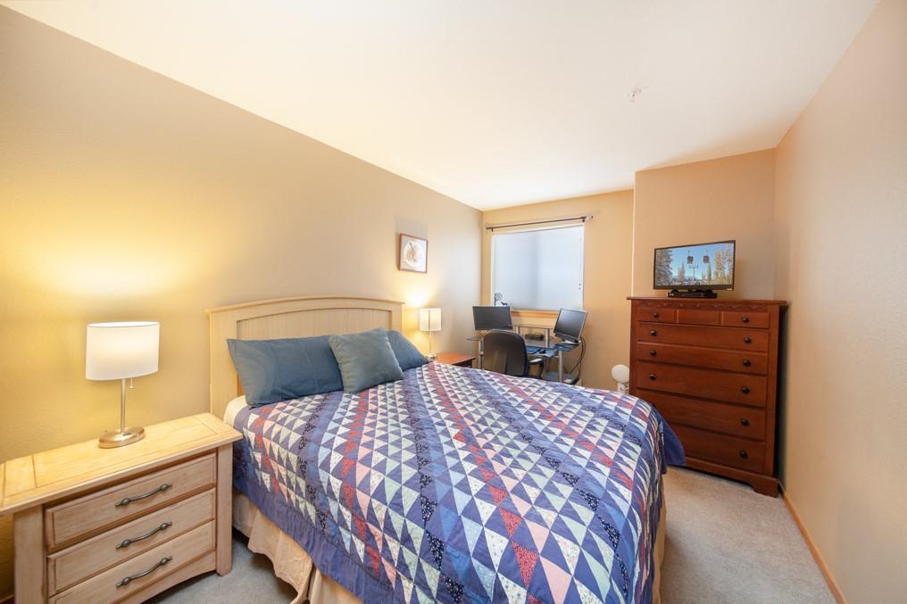 91199 Ryan Gulch Road, Unit A5 Silverthorne, CO 80498 - Photo 14 of 31 a bedroom with a bed and dresser