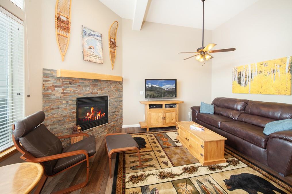 91199 Ryan Gulch Road, Unit A5 Silverthorne, CO 80498 - Photo 4 of 31 a living room with furniture and a fireplace