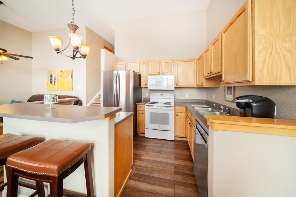 91199 Ryan Gulch Road, Unit A5 Silverthorne, CO 80498 - Photo 6 of 31 a kitchen with stainless steel appliances granite countertop a sink a stove and a refrigerator