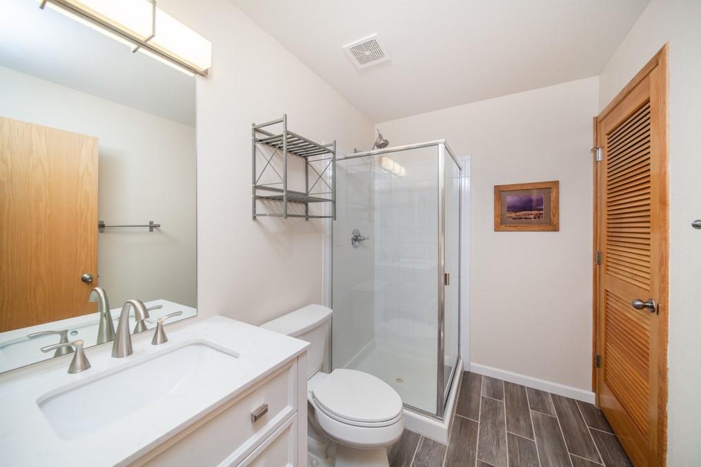 91199 Ryan Gulch Road, Unit A5 Silverthorne, CO 80498 - Photo 7 of 31 a bathroom with a sink a toilet a mirror and shower