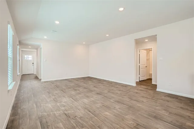 a view of an empty room and wooden floor
