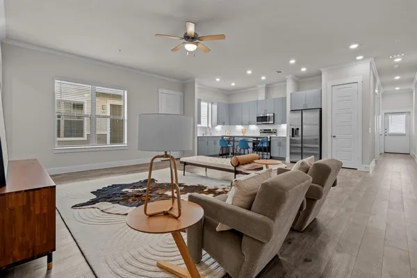 a living room with furniture kitchen and a table