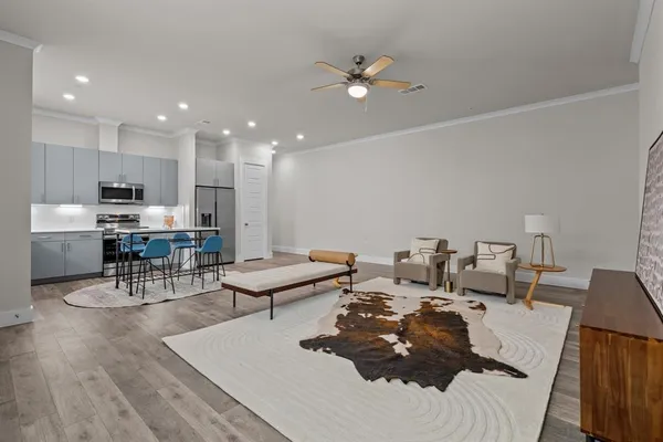 a living room with lots of furniture and kitchen view