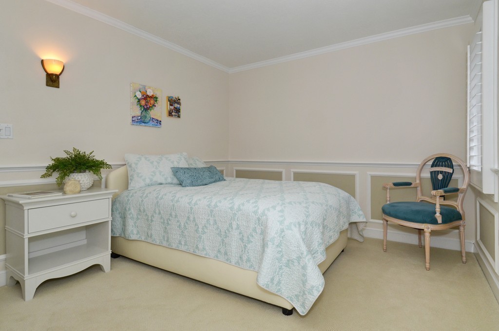 151 Country Club Road Newton, MA 02459 - Photo 26 of 30 a bedroom with a bed and a chandelier