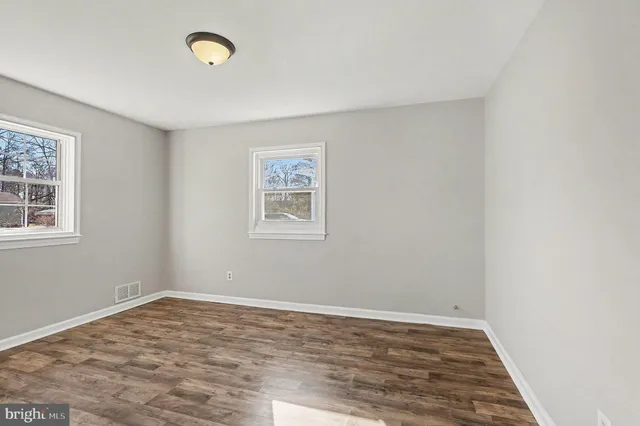 a view of a room with wooden floor and window