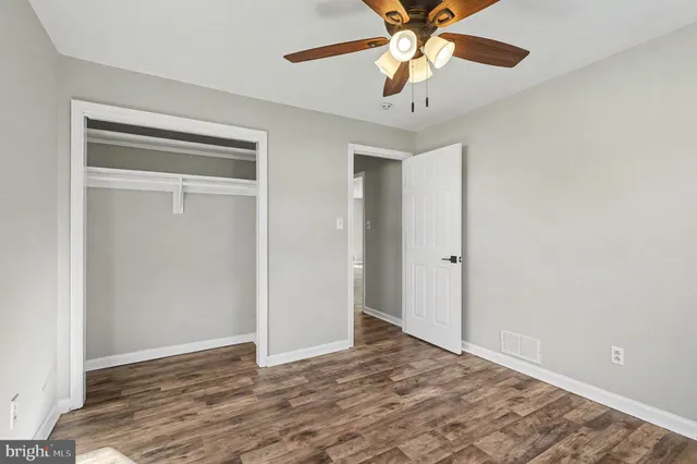 a view of an empty room with a ceiling fan
