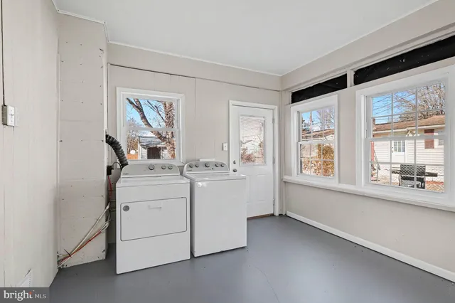 a room with a bed and a large window