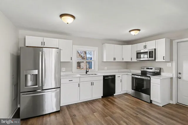 a kitchen with a refrigerator stove and sink