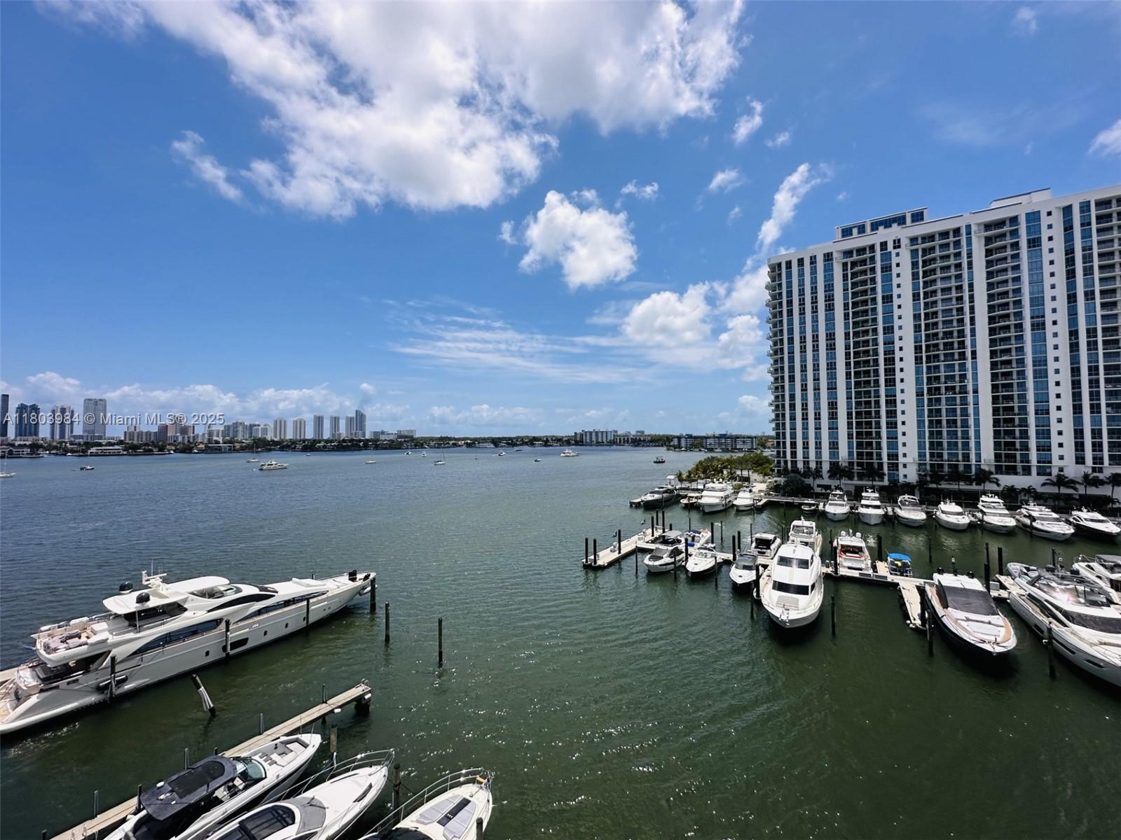 17211 Biscayne Boulevard, Unit 13 Miami, FL 33160 - Photo 4 of 9 a view of a lake with lawn chairs