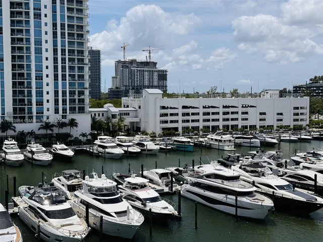 a view of a ocean view with a table chairs and wooden floor