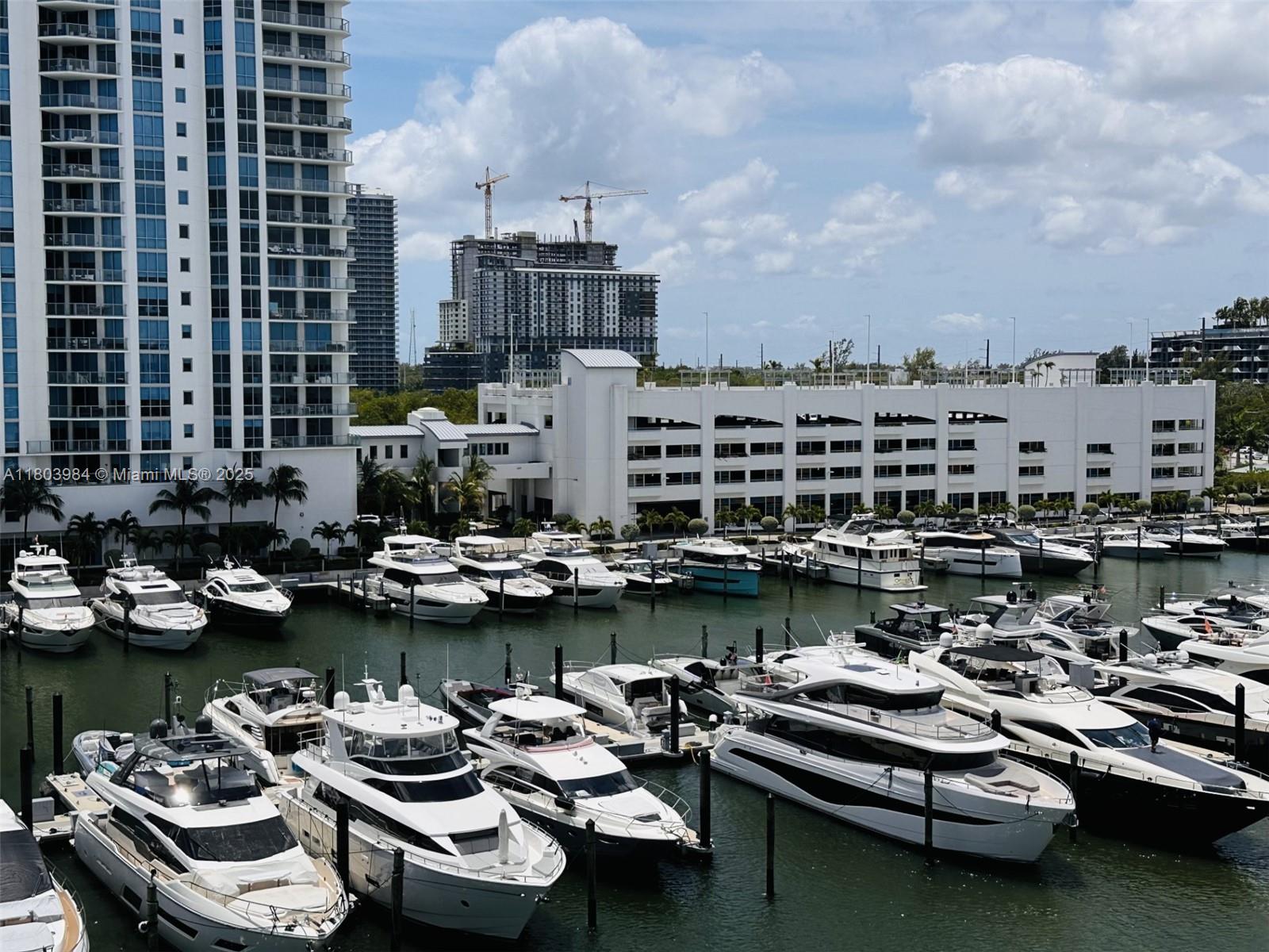 17211 Biscayne Boulevard, Unit 13 Miami, FL 33160 - Photo 6 of 9 a view of a ocean view with a table chairs and wooden floor