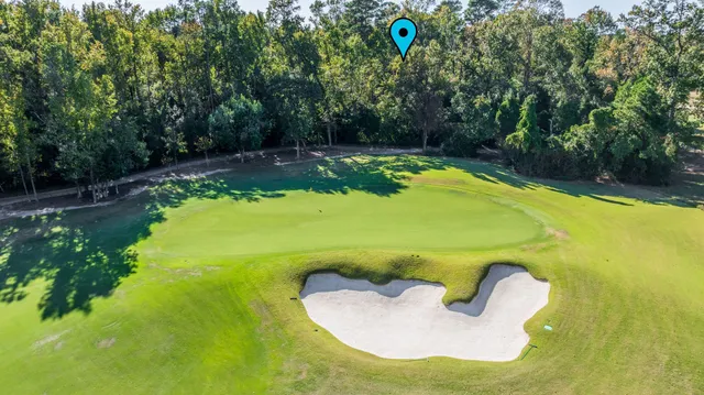 a view of a swimming pool in he middle of the green