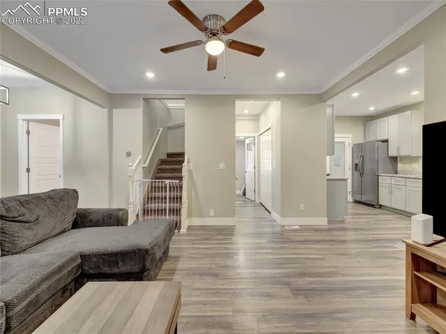 a living room with furniture and a kitchen view