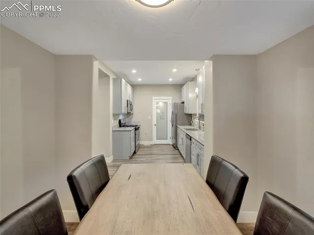 a view of a room with wooden floor and a window
