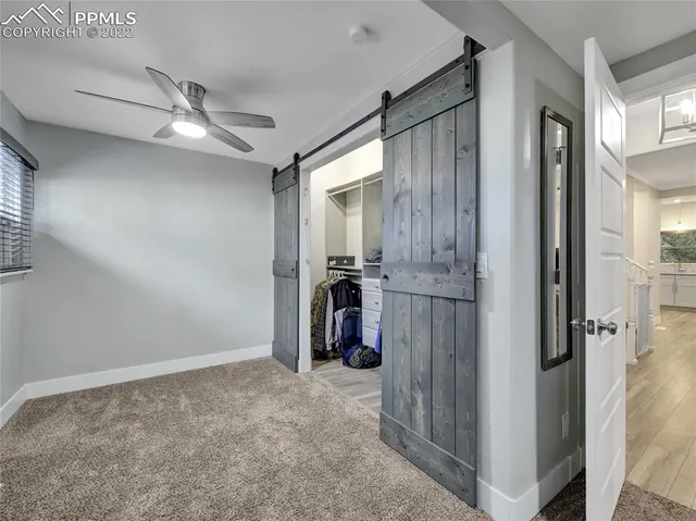 a living room with furniture and a walk in closet
