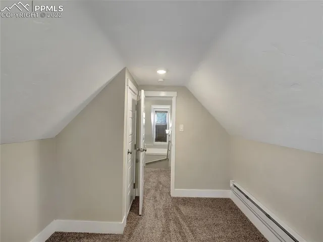 a view of a house with a yard and large trees