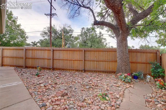 a backyard of a house with table and chairs