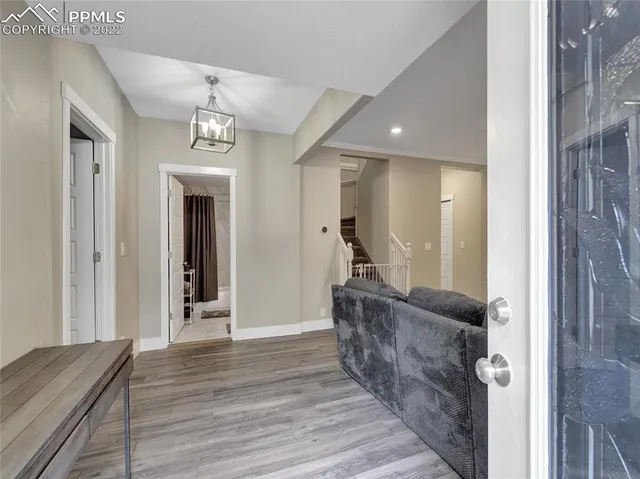 a view of a hallway with wooden floor and staircase