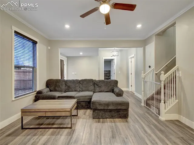 a living room with furniture and a wooden floor