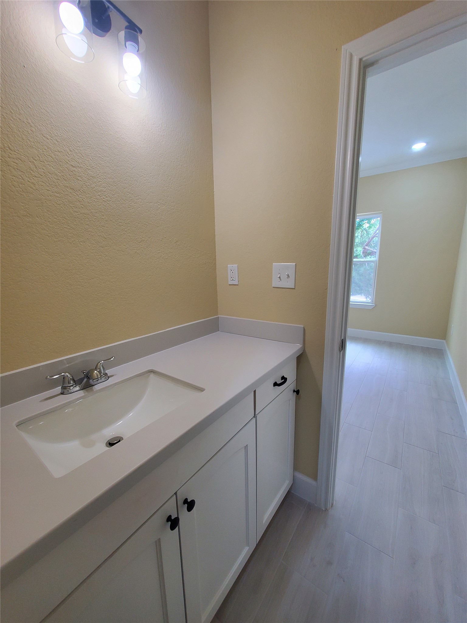 1306 North 9th Street Conroe, TX 77301 - Photo 39 of 47 a bathroom with a sink and a mirror