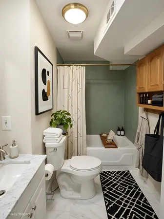 a bathroom with a sink toilet and shower