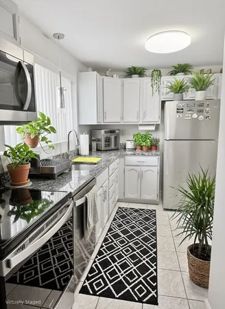 a kitchen with a sink and a stove top oven