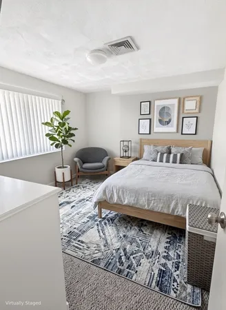 a bedroom with a bed and a couch